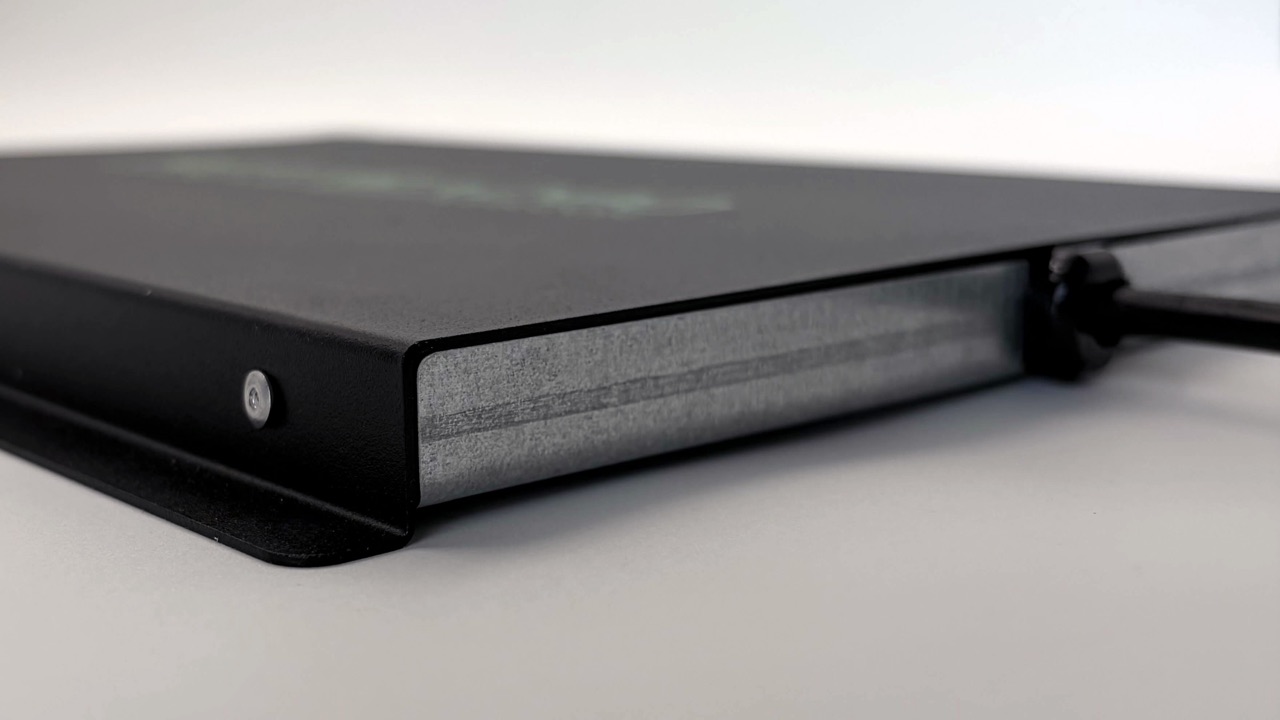 Close-up of the ReptiRad steel casing corner, showing the textured finish, fastener and mounting hole.